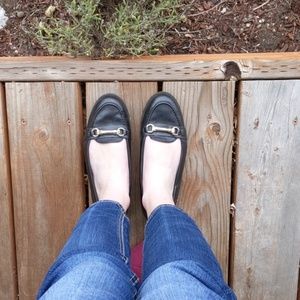 Black loafers with gold accent
